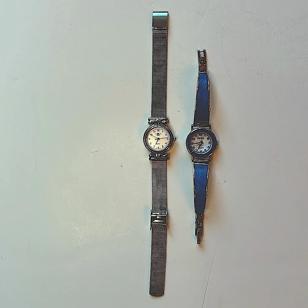 Two vintage quartz watches one stainless steel with hearts one with blue trim